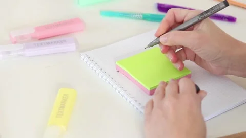 Hands writing exclamation mark on sticky note at white desk Stock Footage 331801607