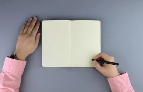Hands writing in the note book. Stock Photos