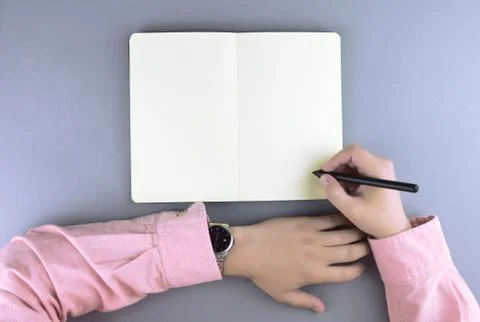 Hands writing in the note book. Stock Photos