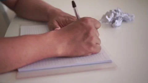 Hands writing notes in a notebook on a desk, Stock Footage 339826574