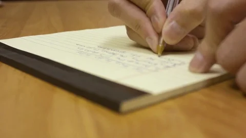 Hands Writing  Notes on a Notepad Stock Footage 79237755
