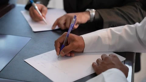Hands Writing on Papers in a Meeting Stock Footage 316347441
