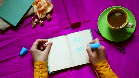Hands writing Stop War, top view from above. Stock-Footage 57745216