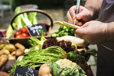 Hands writing a vegetable check list 스톡 사진