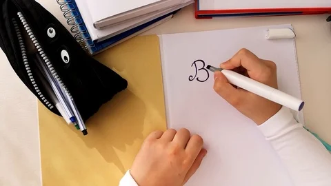 Hands writing on a white paper sheet Back to School. Time-lapse Stock Footage 114016632