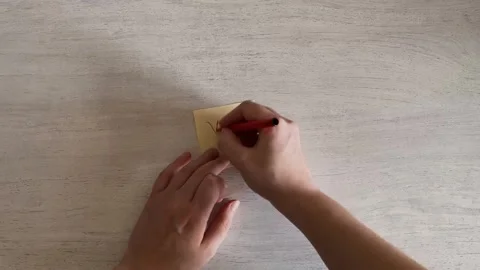 Hands Writing YES on Sticky Note with Red Marker Approval Concept Stock Footage 324702586