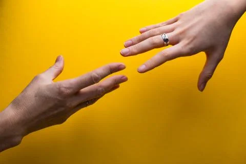 Hands on a yellow background Foto stock
