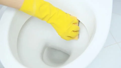 Hands on yellow gloves cleaning a WC Video stock 57906993