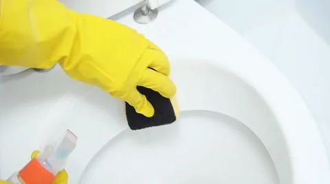 Hands on yellow gloves cleaning a WC Stock Footage 57908511