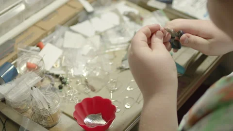 Hands of Young Artist Making Wire and Bead Jewelry - Shallow DOF Stock Footage 146346683