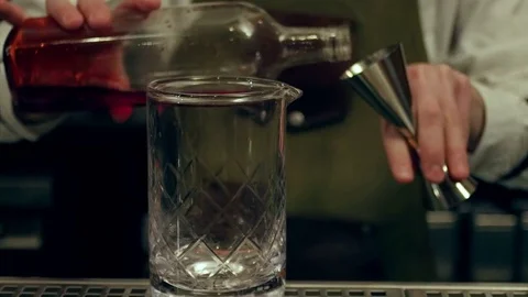 Hands of young bartender preparing one red cocktail with ice Stock-Footage 73718552