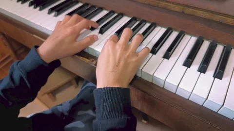 Hands of a young boy playing the piano during lessons. Stock Footage 252927188