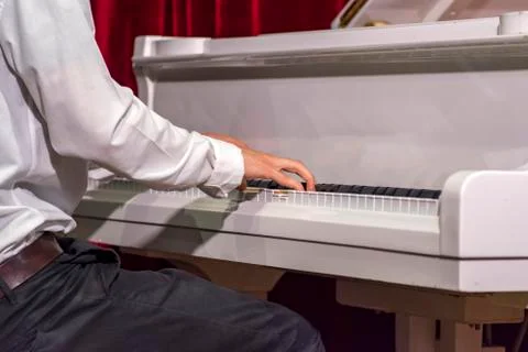 Hands of young boy while plays piano Stock Photos