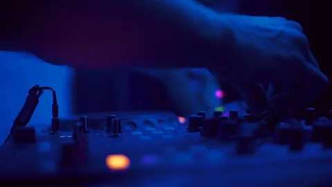 Hands of young Caucasian man playing on DJ booth at club, enjoying. Close-up Stock Footage 95929097