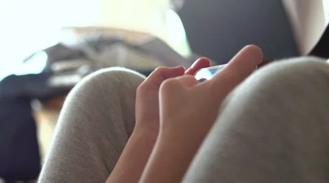 Hands of young child playing game on cell phone Stock Footage 38046594