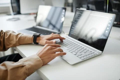 Hands of young contemporary program developer typing on laptop keyboard Stock Photos