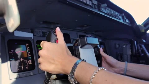 Hands of a Young Female Pilot at the Flight Controls of a Jet Airplane. Captain Stock Footage 346637275