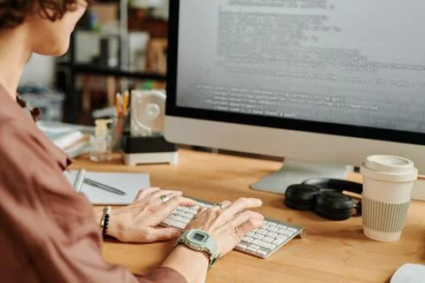 Hands of young female programmer typing on computer keyboard Stock-Fotos