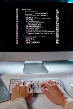 Hands of young female programmer typing on keyboard while decoding data Stock Photos