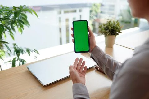 Hands of young female software developer presenting new mobile application Stock Photos