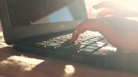 Hands of a Young Girl type on Notebook keyboard. HIghkey light. Dreamy mood Stock Footage 99833943