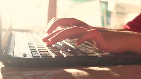 Hands of a Young Girl type on Notebook keyboard. HIghkey light. Dreamy mood Stock Footage 99834565