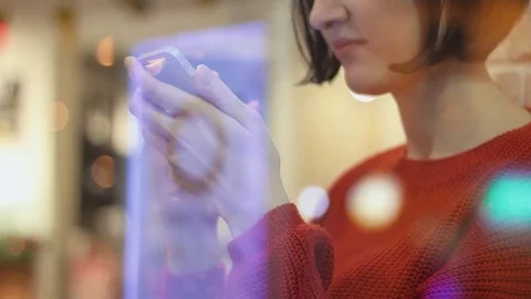 Hands of young girl using smartphone. Handsome woman in cafe in evening Stock Footage 83082802