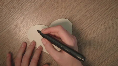 Hand's of young girl write phrase i luv u on white paper heart. Romantic stuff Stock-Footage 124243700