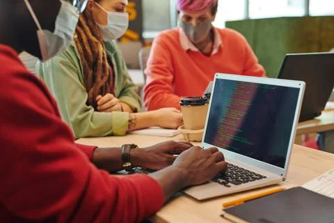 Hands of young it engineer of African ethnicity working over new program 스톡 사진