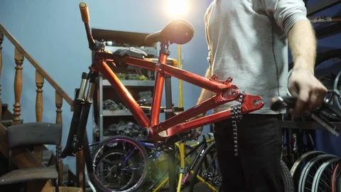 A hands of young mahanic fixing a treadles on a bike. Close-up Stock Footage 86446919