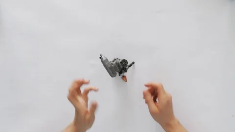 The hands of a young man-engineer holding a micromotor for auto or air racing 库存影片 105317613