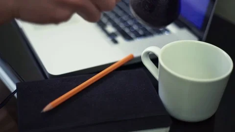 Hands of young man pouring steaming coffee into cup at kitchen. Stock Footage 82928504