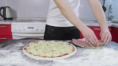 Hands of young man put meet on pizza dough 動画素材 127694559
