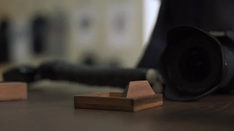 Hands of a young man solving interlocking wooden puzzle with camera on the Video stock 104642967