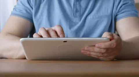 A hands of young man with a tablet PC at the table at home 動画素材 66466403