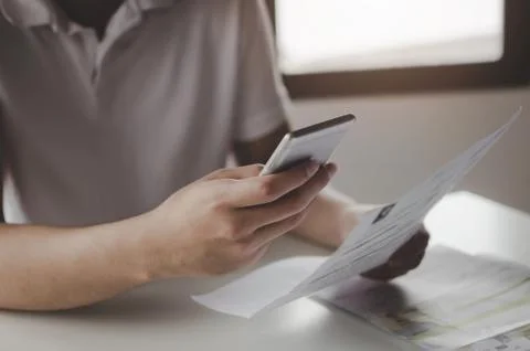Hands of young man using mobile smart phone for scan and payment online Stock Photos