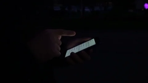Hands of a young man using smart cell phone at night in the city street Stock Footage 80016612