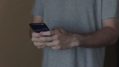 Hands of young man using smartphone Video stock 130235338