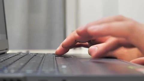 Hands of a young man working at a computer. The programmer is typing on a gaming Stock Footage 228483140