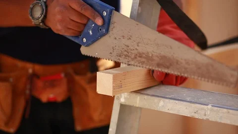 Hands of young man working cutting plank with wood handsaw Stock Footage 120534834