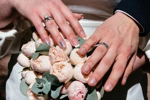 Hands of young people with wedding wedding rings. wedding day details. calla Stock Photos