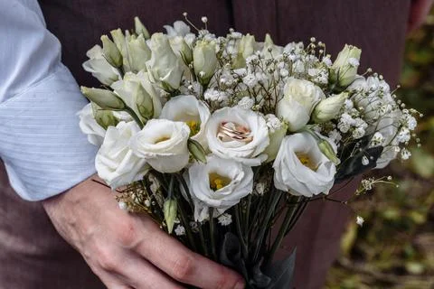 Hands of young people with wedding wedding rings. wedding day details. calla Stock Photos