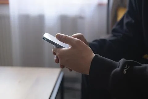 Hands of young person using smartphone indoors close up 스톡 사진