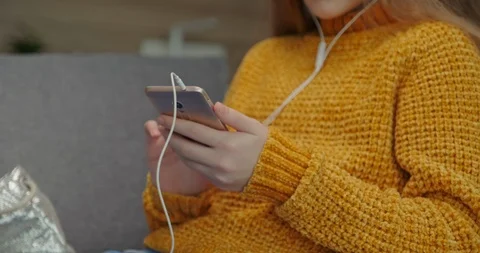 Hands young student texting in cell phone, when she listening music in earphones Stock Footage 127250826