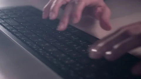 Hands of a young woman on computer keyboard. The camera is in motion - on dolly Stock Footage 87361045