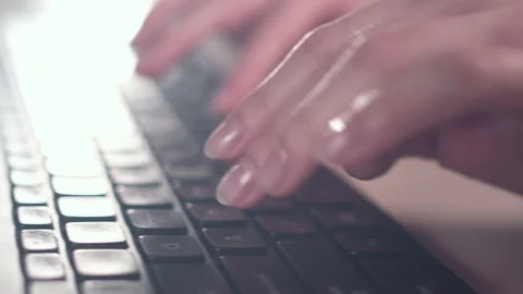 Hands of a young woman on computer keyboard. The camera is in motion - on dolly Stock Footage 87363031