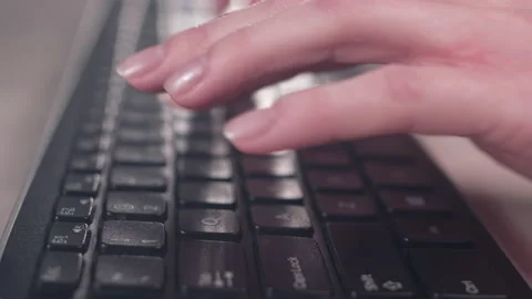 Hands of a young woman on computer keyboard. The camera is in motion - on dolly Stock Footage 87367449