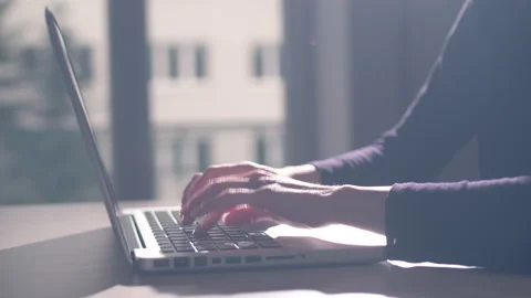 Hands of a young woman on computer keyboard. The camera is in motion - on dolly Stock Footage 87368637