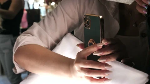Hands of a young woman using a mobile phone shoots a video or takes a photo Stock Footage 209159526