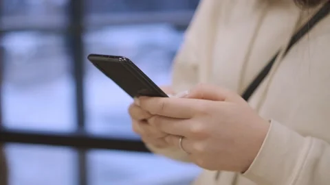 Hands of young woman using smartphone in shopping mall. Communication, online Video stock 168418255